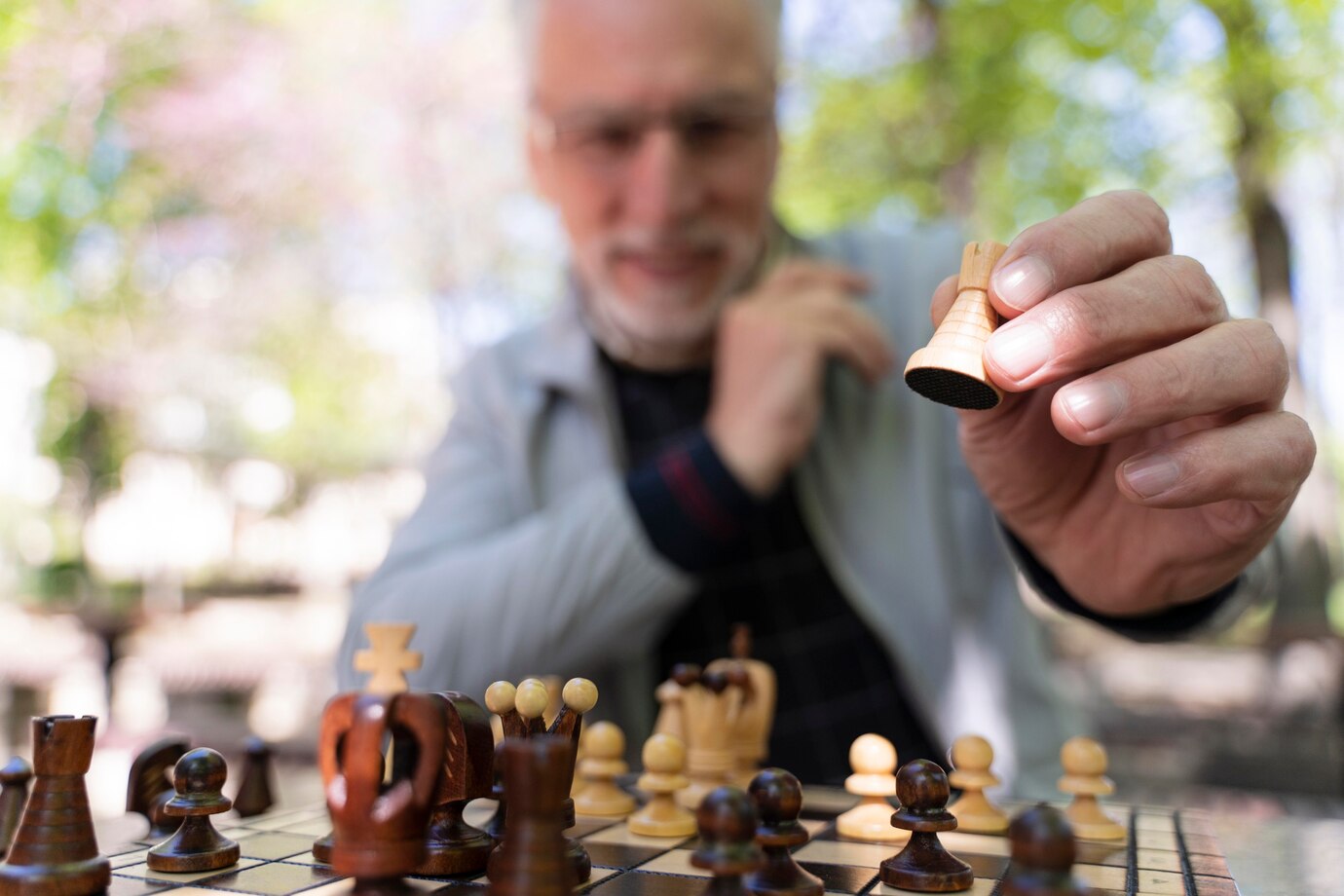 close-up-blurry-old-man-playing-chess_