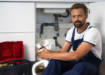 plumbing professional doing his job in the bathroom