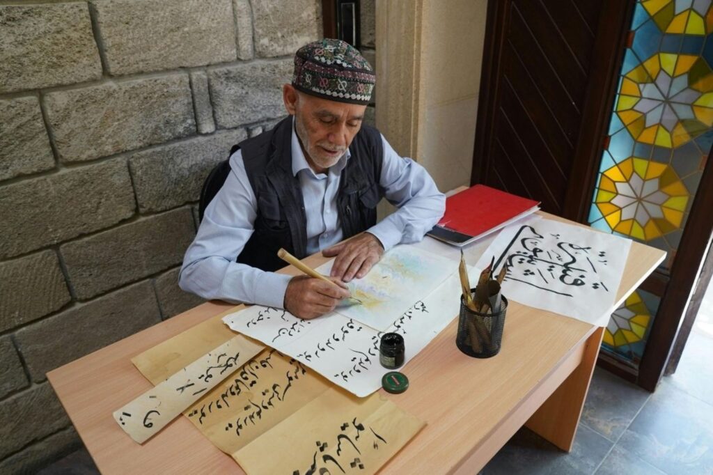 Moroccan calligrapher creating traditional Arabic script artwork Moroccan Calligraphy traditional art Islamic cultural