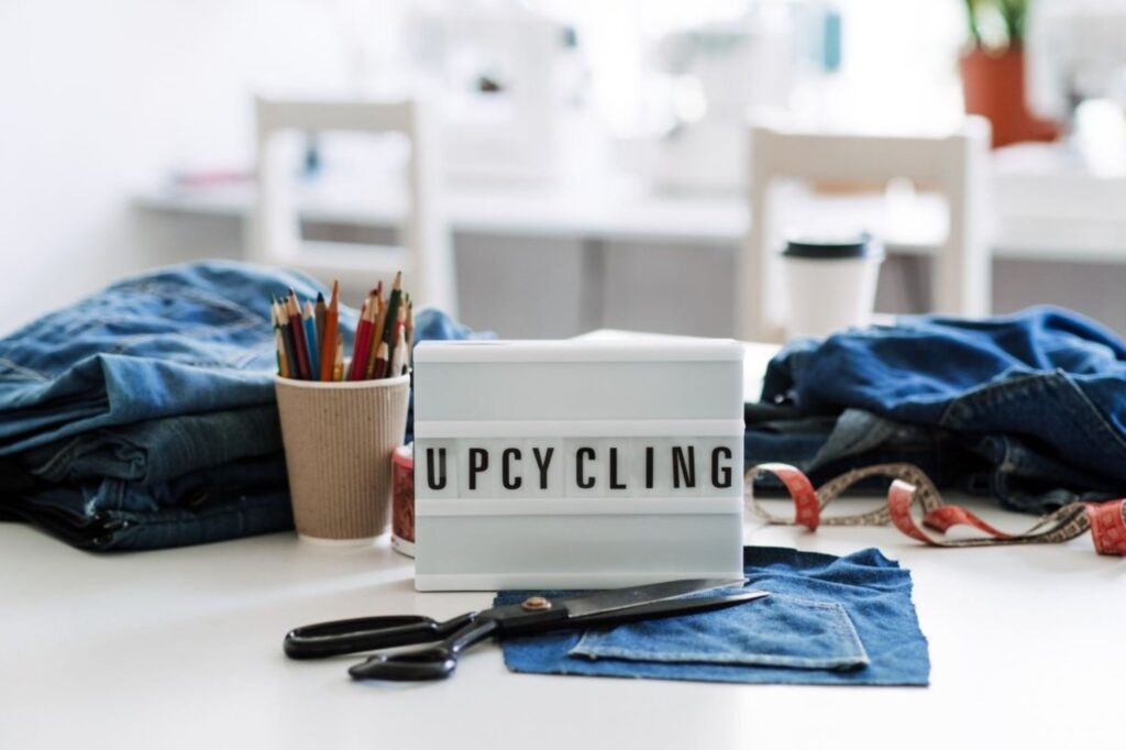 Moroccan slow fashion artisan selecting upcycled vintage fabrics and natural dyes for ethical sustainable fashion production honoring traditional craftsmanship