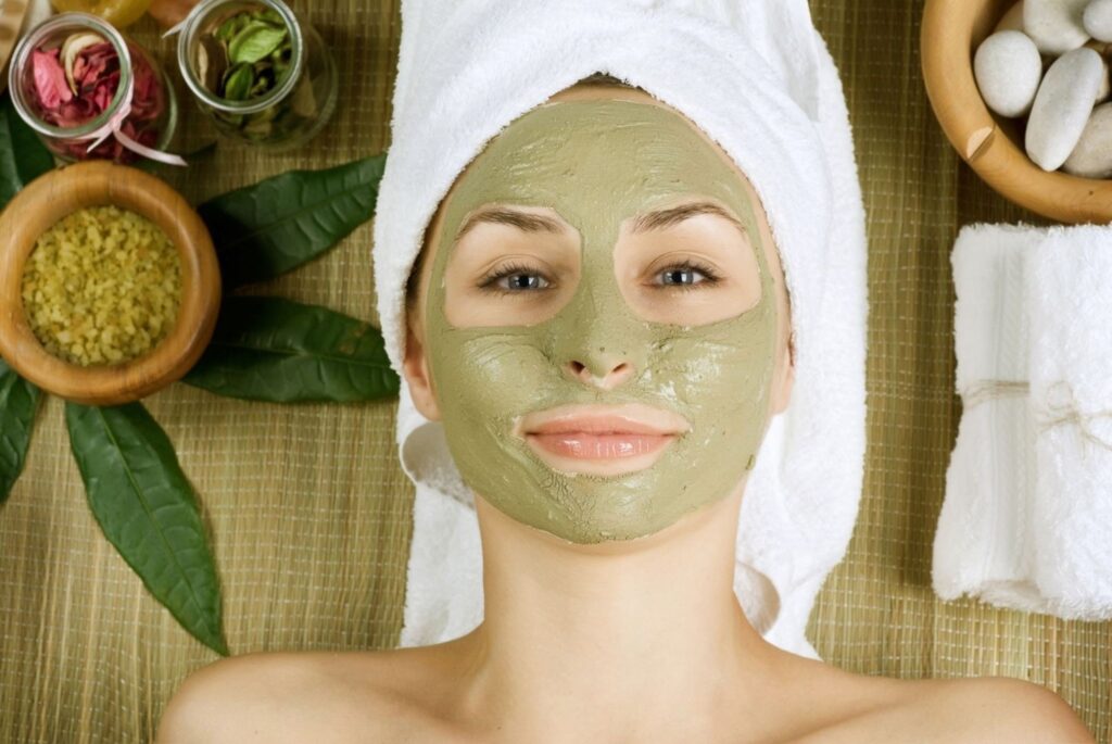 Woman applying natural clay face mask beauty treatment face masks natural skin glow