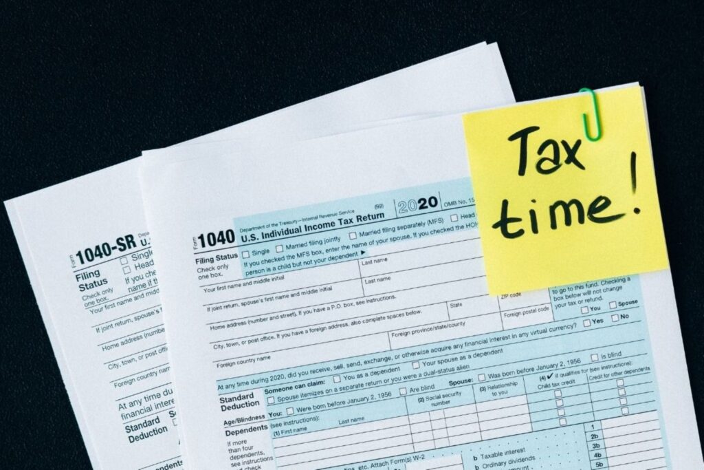 Business calculator and financial documents for Morocco year-end tax planning showing quarterly payments and deductions, representing strategic fiscal year-end optimization for small business owners