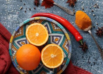 Traditional Moroccan spiced oranges arranged on decorative plate during citrus season, featuring fresh Navel oranges with cinnamon and orange blossom water for authentic dessert recipes