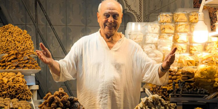 Souk negotiation Moroccan merchant smiling customer market stall