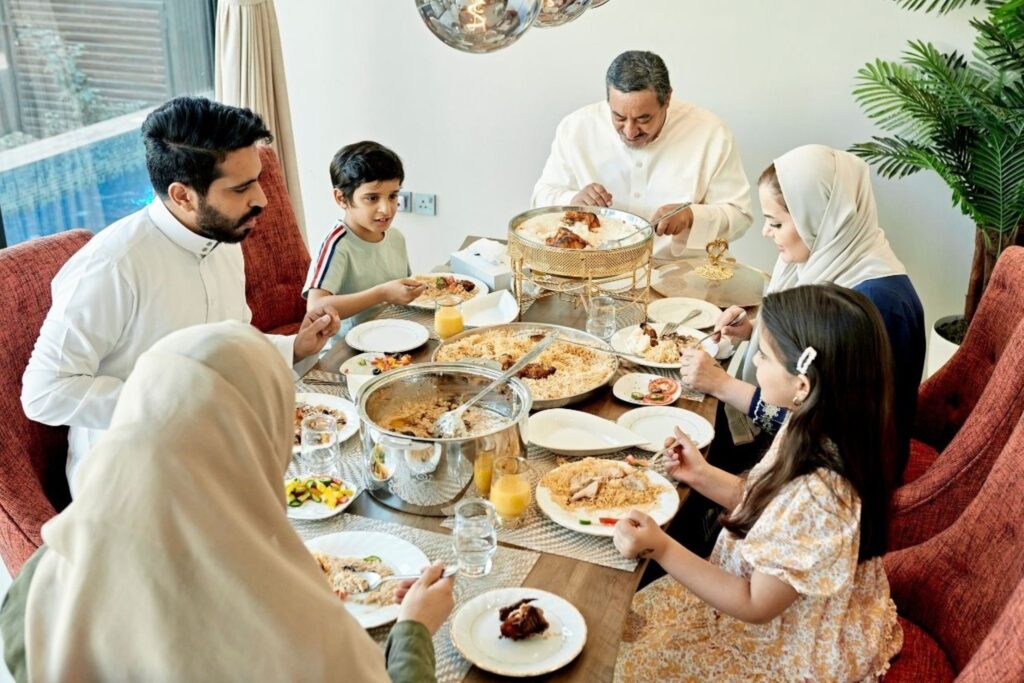Moroccan family dressed in traditional djellabas celebrating Eid al-Adha Morocco together at home