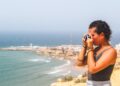 Een vrouw loopt langs het Agadir-strand bij zonsopgang en geniet van een junimorgen aan de Atlantische kust van Marokko tijdens een Agadir-weekend