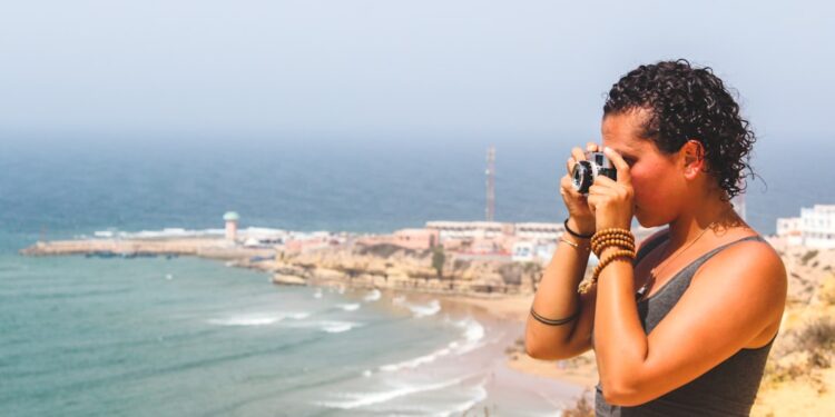 Een vrouw loopt langs het Agadir-strand bij zonsopgang en geniet van een junimorgen aan de Atlantische kust van Marokko tijdens een Agadir-weekend