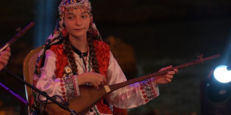 amazigh-woman-musician-performing-stage-unsplash - MAwebzine A female Amazigh musician performs on stage at the Timitar Festival in Agadir, Morocco