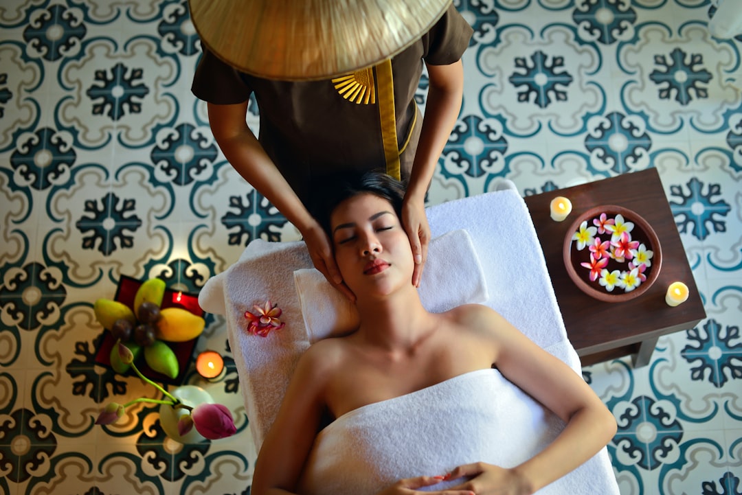 A woman applying beldi soap in a hammam setting as part of a traditional Moroccan beauty ritual