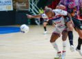 A Moroccan handball player celebrates during an African handball championship match in front of a passionate crowd