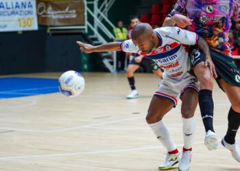 A Moroccan handball player celebrates during an African handball championship match in front of a passionate crowd