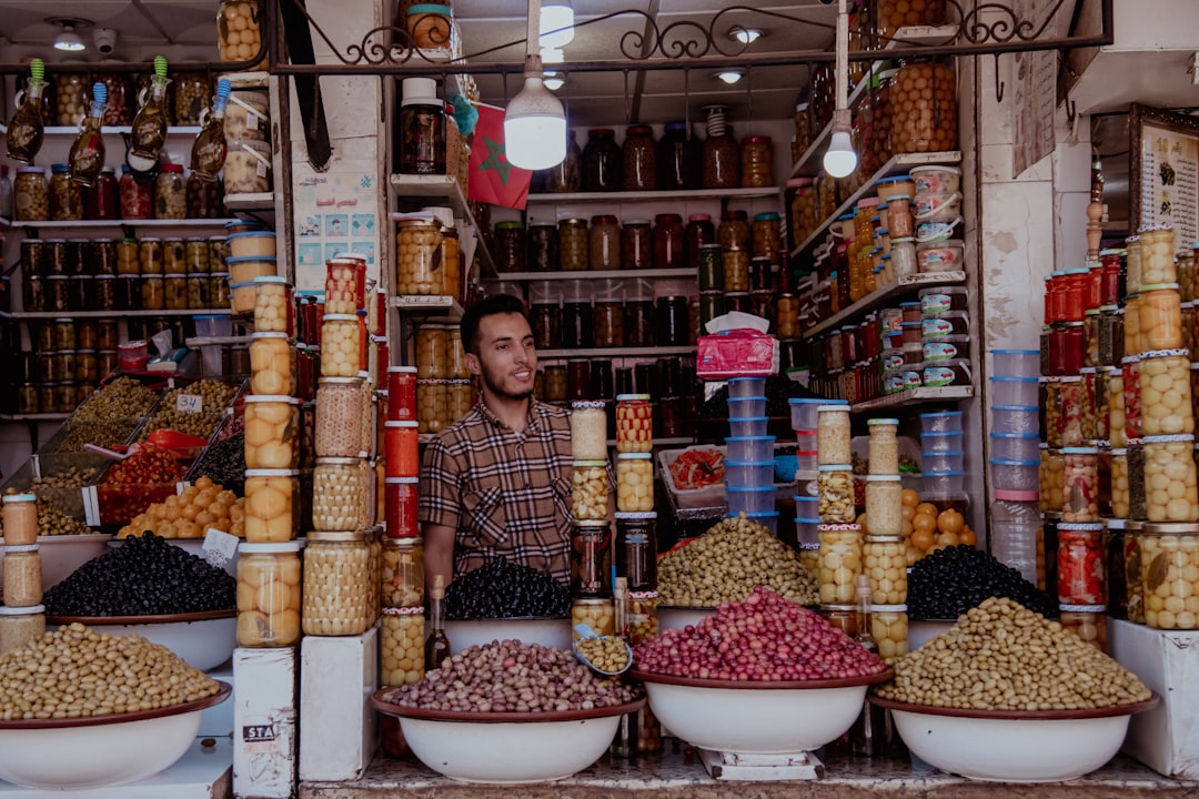 A local artisan at a market stall showing how conscious shopping can reduce plastic use in Morocco's souks