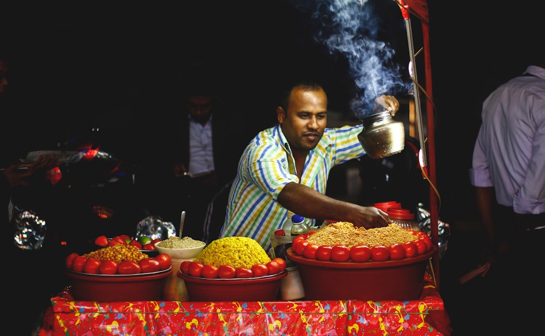 A street vendor hands a bowl of bissara fava bean soup to a customer, one of the most beloved gluten-free Moroccan food