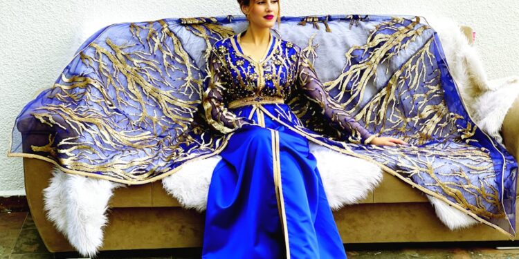 moroccan-woman-caftan-designer-atelier-unsplash - MAwebzine A Moroccan designer showing how Moroccan designers bridge royal textile heritage and modern fashion.