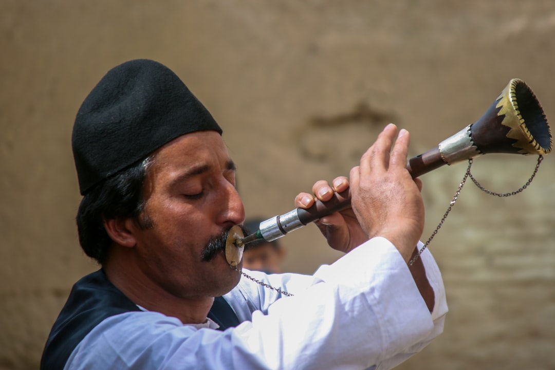 A man plays a traditional Moroccan instrument during a Timitar Festival cultural performance in Agadir