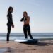 surf-instructor-teaching-beginner-on-beach-unsplash - MAwebzine A certified coach at one of Morocco's surf schools helps a beginner stand on a board for the first time on the Atlantic coast
