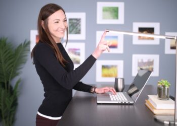 A businesswoman reviews wealth management data at her desk inside a Casablanca Finance City tower office