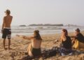 People enjoying the beach along Essaouira’s Atlantic coast in Morocco, with ocean waves and a scenic coastal atmosphere