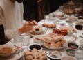 A Moroccan family gathered around a shared tagine during Throne Day celebrations in a traditional home