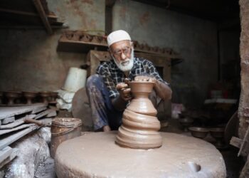 A Fassi artisan demonstrates Moroccan pottery hand-throwing technique on a foot-powered wheel in Ain Nokbi