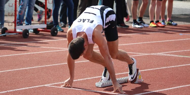 A runner training at a Moroccan athletics club track during a morning session