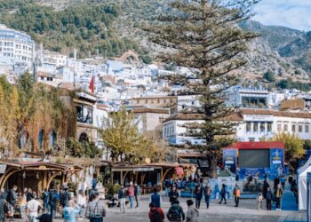 A traveler navigating the narrow streets of Fez's medina, one of Morocco's most iconic imperial cities