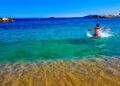 A swimmer glides through the calm turquoise water during open water swimming on Morocco's Mediterranean coast near Al Hoceima
