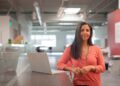 A female founder reviews documents at her desk while registering her startup in Morocco's free zones