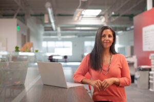 A female founder reviews documents at her desk while registering her startup in Morocco's free zones