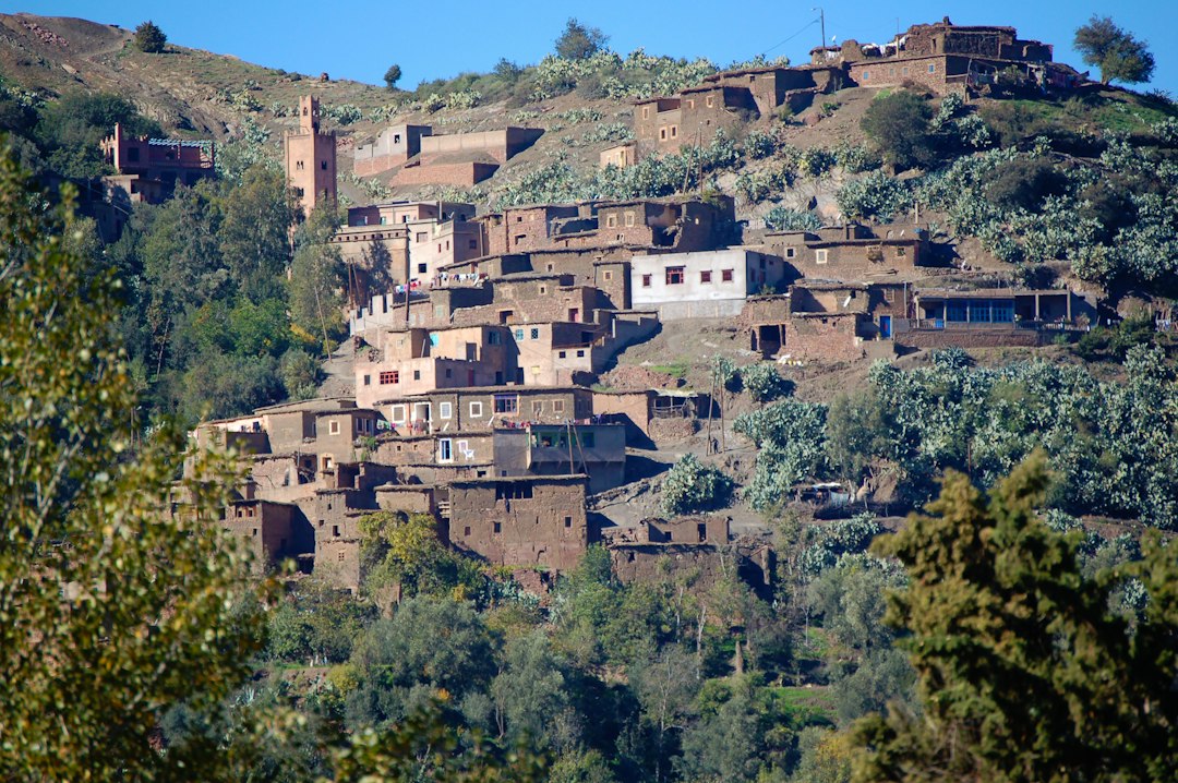 A cyclist resting in a remote Berber village along a Moroccan cycling route through the southern Anti-Atlas