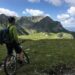 cyclist-cycling-in-mountain-unsplash - MAwebzine A road cyclist ascending a steep Moroccan cycling route through the High Atlas Mountains at sunrise