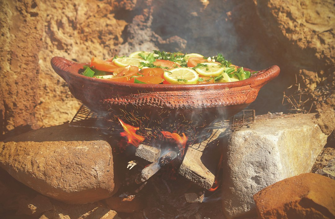 Una cocinera casera marroquí añade verduras de temporada a un tajine de barro, un elemento básico de la cocina de otoño en los hogares marroquíes