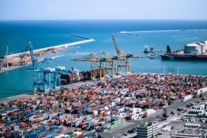 A freight logistics worker inspects containers at Tanger Med port, where post-summer freight demand peaks each autumn