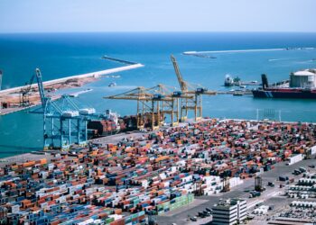 A freight logistics worker inspects containers at Tanger Med port, where post-summer freight demand peaks each autumn