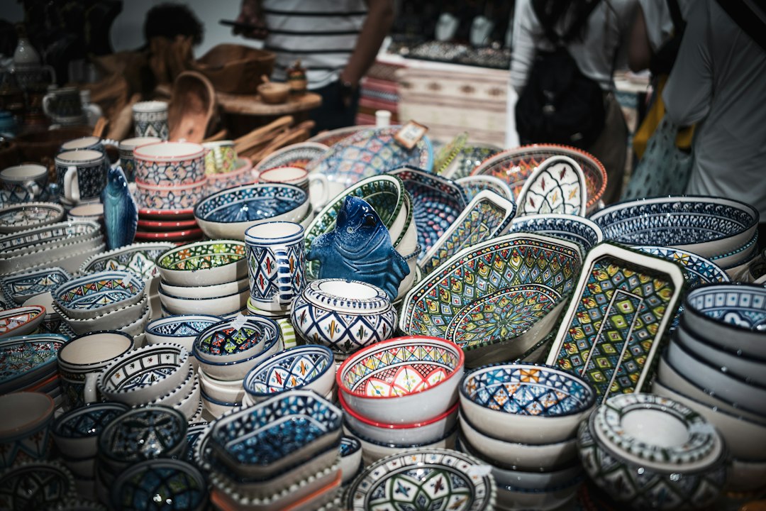 Shopper choosing clay and tools for a pottery hobby at a Moroccan souk