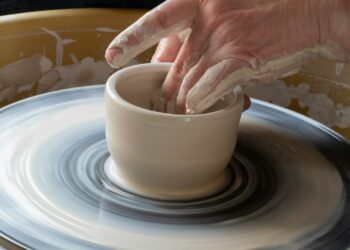 Beginner practicing a pottery hobby on a wheel in a Moroccan studio